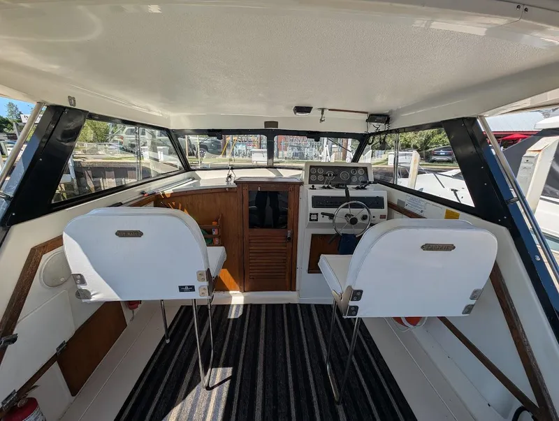 Slide: The Image of 1977 Trojan F30 Express boat interior with steering wheel, dashboard, and seating. - 14