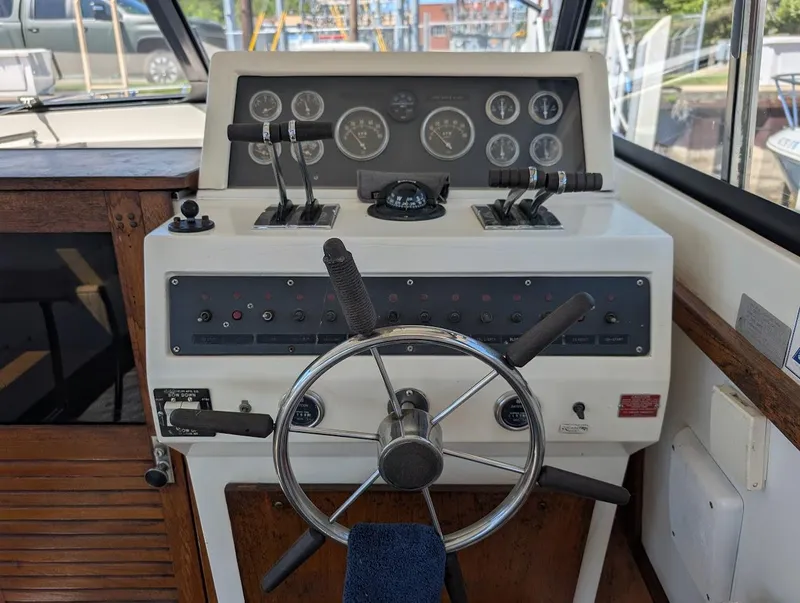 Slide: The Image of 1977 Trojan F30 Express boat helm with steering wheel and control panel. - 15