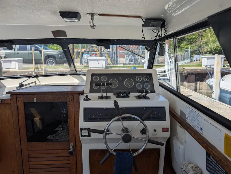 Slide: The Image of 1977 Trojan F30 Express boat interior with steering wheel and control panel. - 17