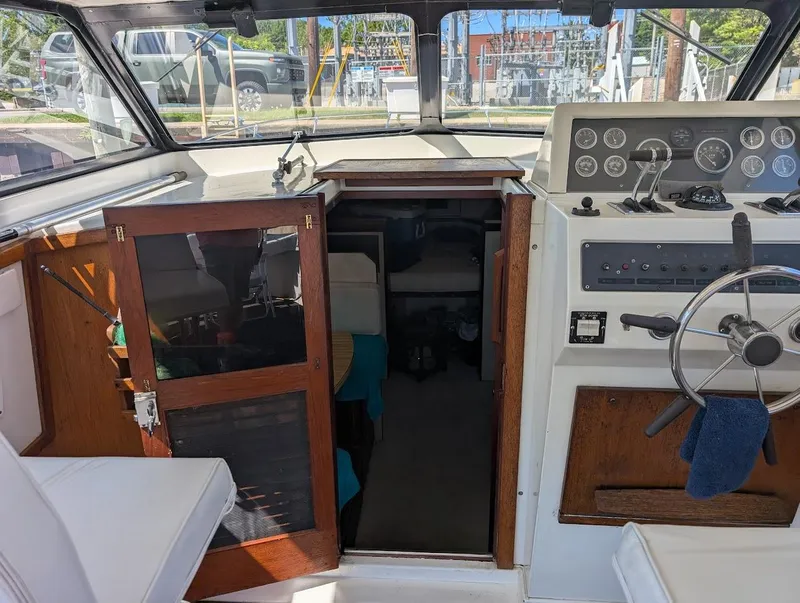Slide: The Image of 1977 Trojan F30 Express boat interior with steering wheel and control panel. - 21