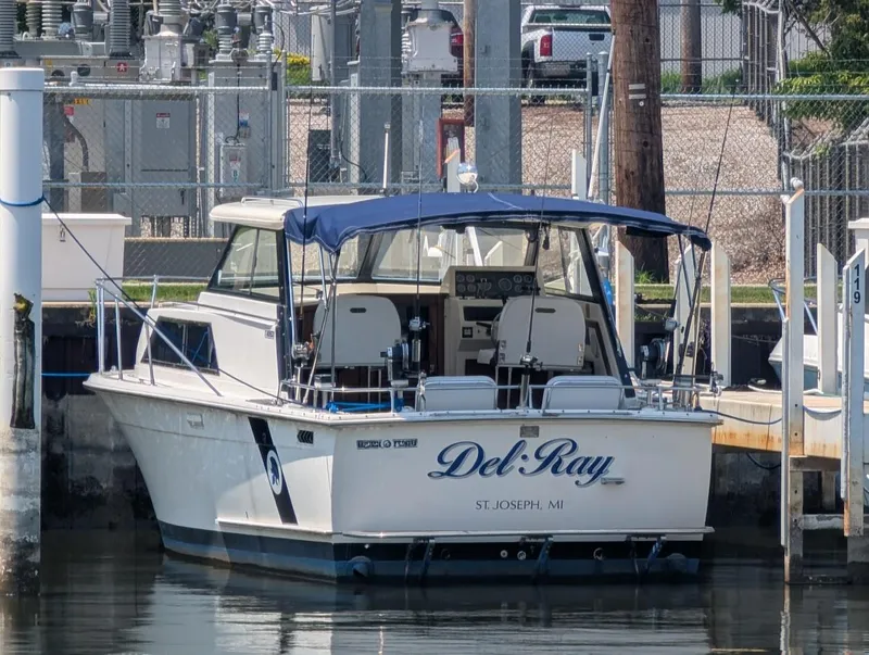 Slide: The Image of 1977 Trojan F30 Express boat named "Del Ray" docked at a marina. - 3