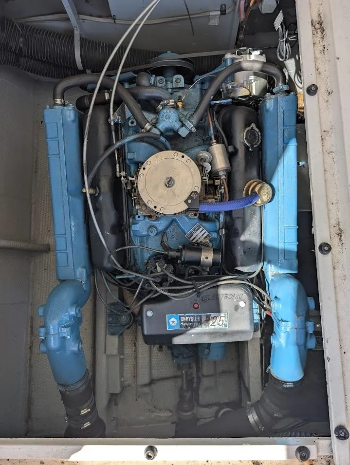 Slide: The Image of 1977 Trojan F30 Express engine compartment with blue marine engine components. - 34