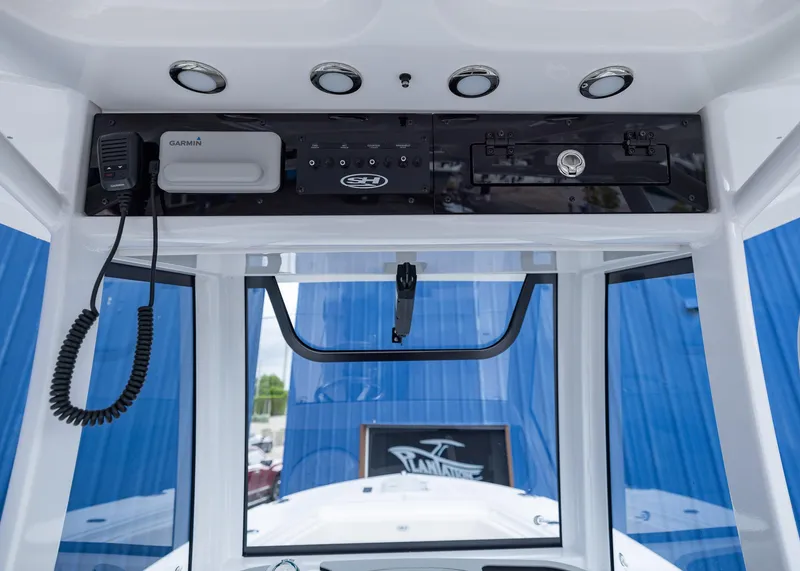 Slide: The Image of 2026 Sea Hunt Gamefish 27 Coffin Box boat console with Garmin electronics and storage compartments. - 10