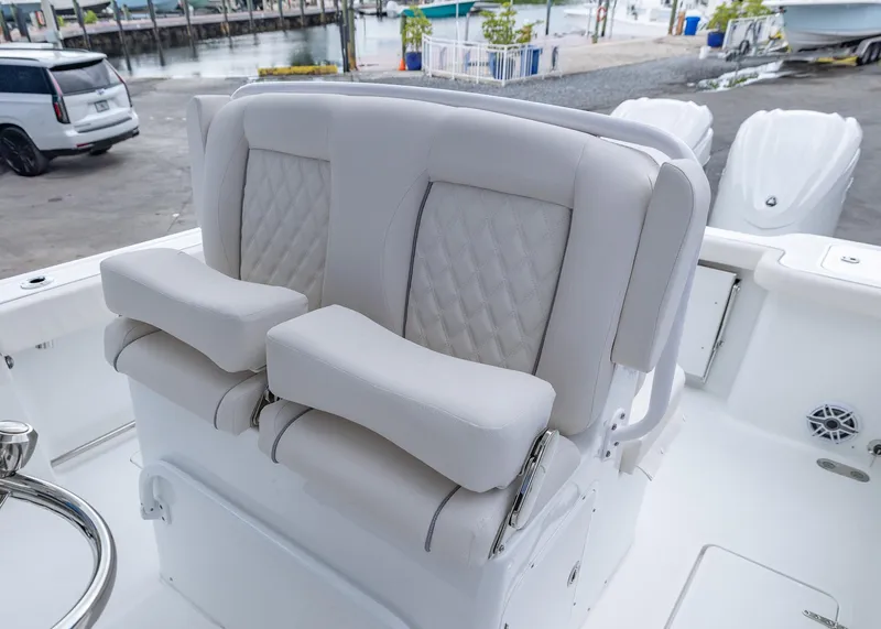 Slide: The Image of 2026 Sea Hunt Gamefish 27 Coffin Box boat seating with cushioned armrests and quilted design. - 11