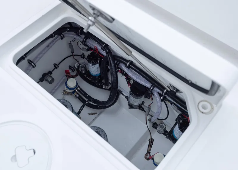 Slide: The Image of Open compartment of 2026 Sea Hunt Gamefish 27 Coffin Box showing internal components and wiring. - 22