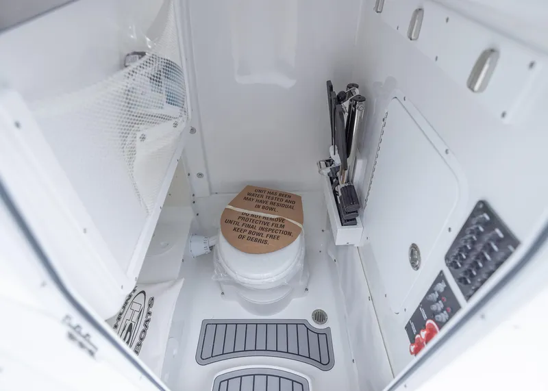 Slide: The Image of Interior of 2026 Sea Hunt Gamefish 27 Coffin Box boat, featuring storage and control panels. - 26