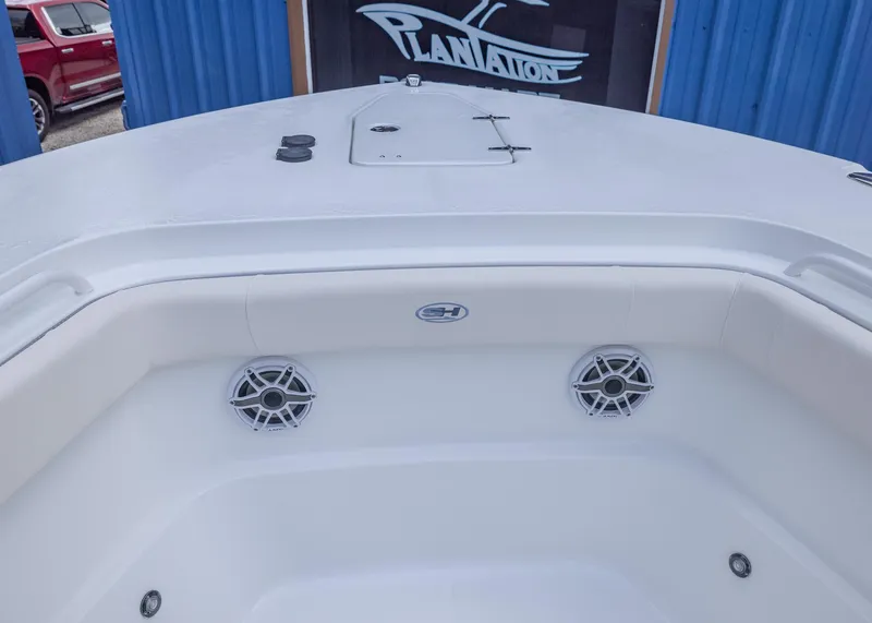 Slide: The Image of 2026 Sea Hunt Gamefish 27 Coffin Box boat interior with speakers and storage. - 5