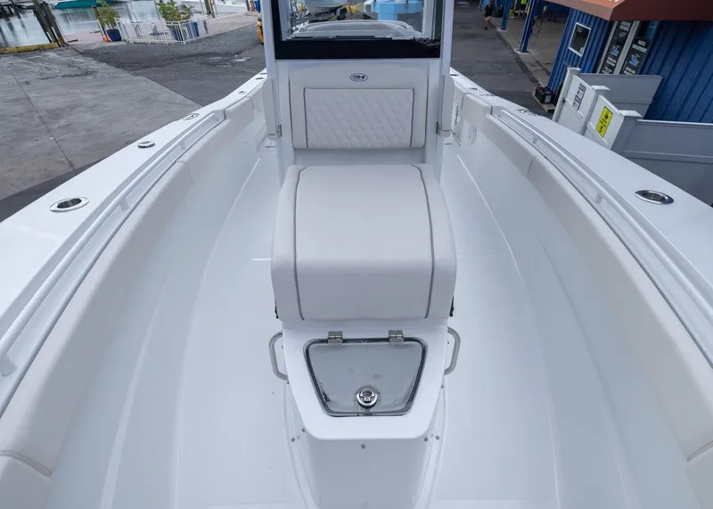 Slide: The Image of 2026 Sea Hunt Gamefish 27 Coffin Box boat interior, featuring sleek white seating and storage. - 7