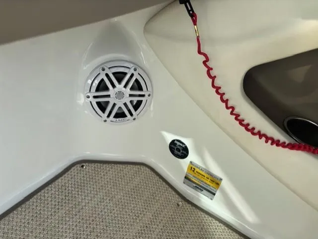 Slide: The Image of Interior of a 2006 Cobalt 220 boat featuring a speaker and safety lanyard. - 11