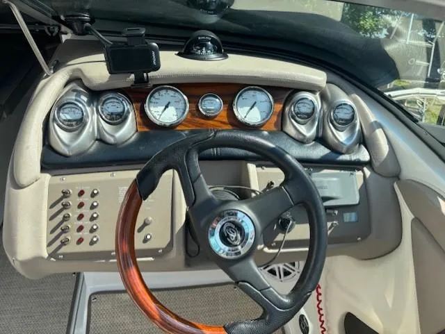 Slide: The Image of Dashboard of a 2006 Cobalt 220 boat with gauges and wood-accented steering wheel. - 8