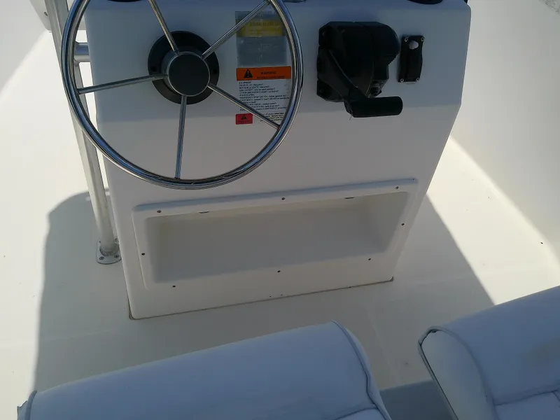Slide: The Image of Steering console of 2000 Hydra-Sports 212 Seahorse CC boat, featuring wheel and controls. - 25