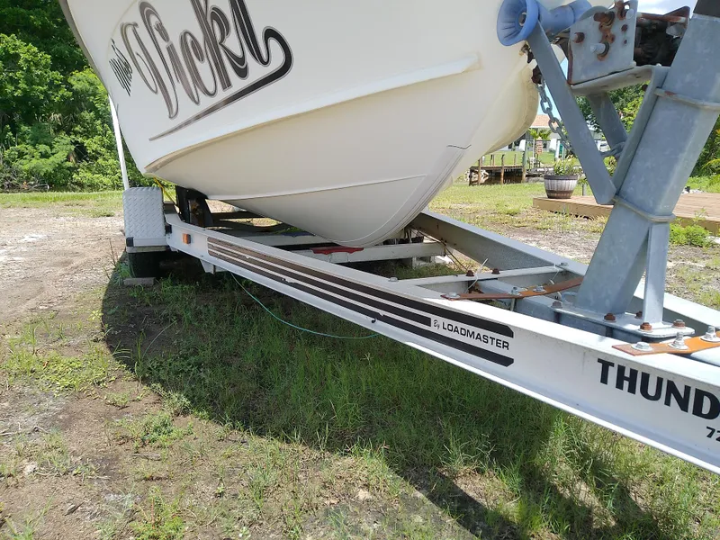 Slide: The Image of 2000 Hydra-Sports 212 Seahorse CC boat on Loadmaster trailer, parked on grass. - 3