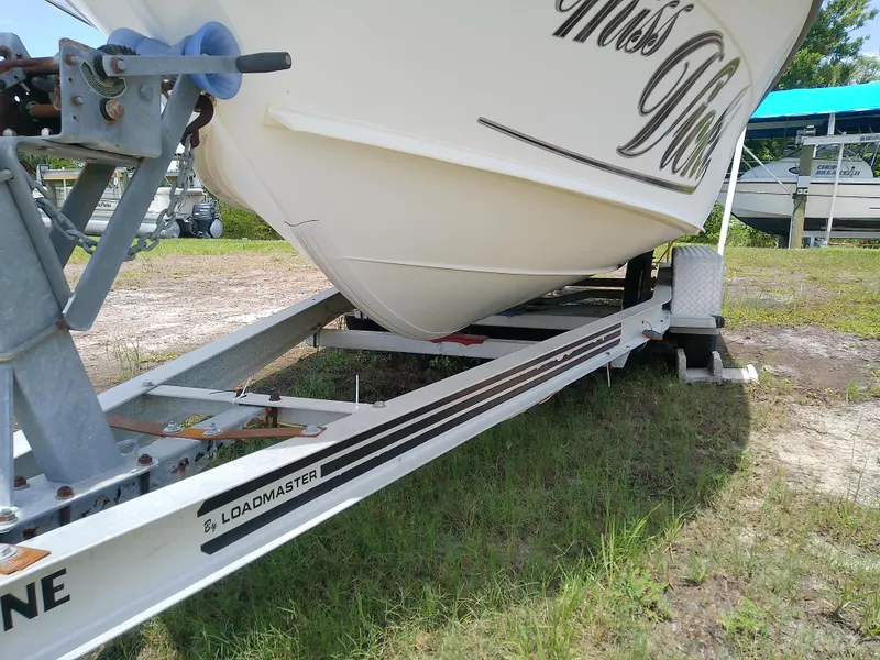 Slide: The Image of 2000 Hydra-Sports 212 Seahorse CC boat on Loadmaster trailer, parked on grass. - 4