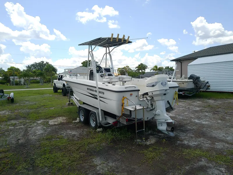 Slide: The Image of 2000 Hydra-Sports 212 Seahorse CC boat on trailer, parked outdoors under a cloudy sky. - 5