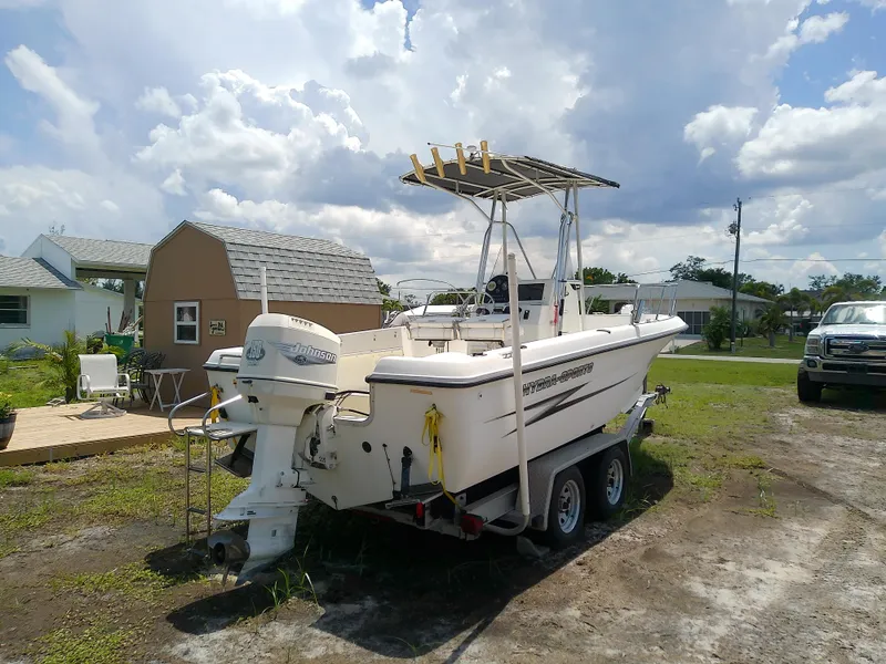 Slide: The Image of 2000 Hydra-Sports 212 Seahorse CC boat on trailer, parked outdoors under cloudy sky. - 6