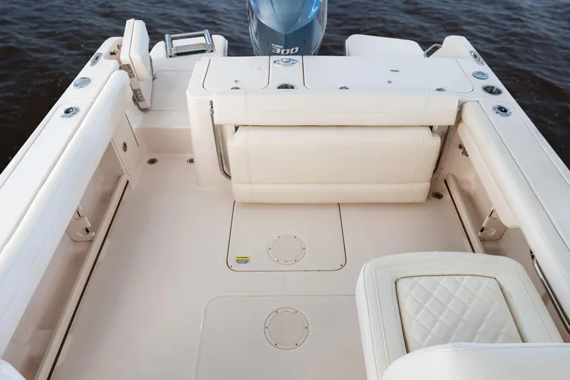 Slide: The Image of 2026 Grady-White GW 235 Freedom boat interior with cushioned seating and motor. - 5