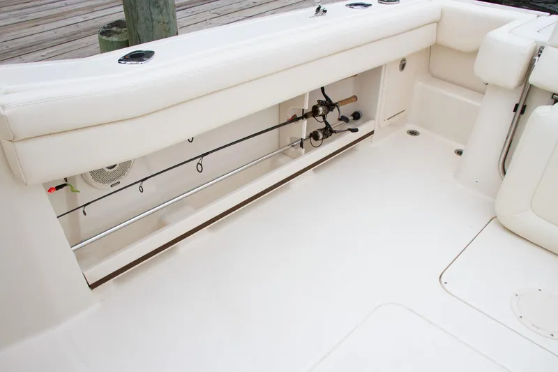 Slide: The Image of 2026 Grady-White GW 235 Freedom boat interior with rod storage and seating. - 7
