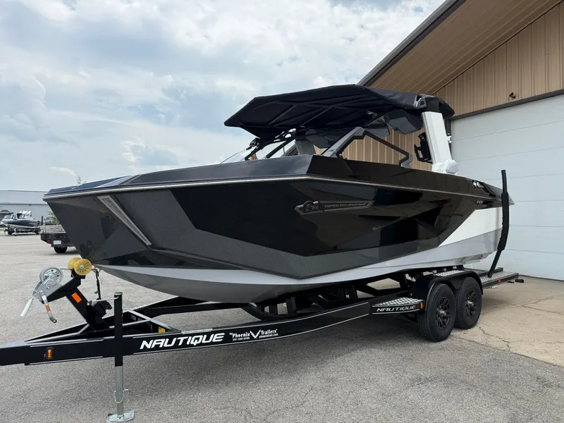 Slide: The Image of 2025 Nautique Super Air Nautique G23 boat on trailer, parked outdoors. - 13