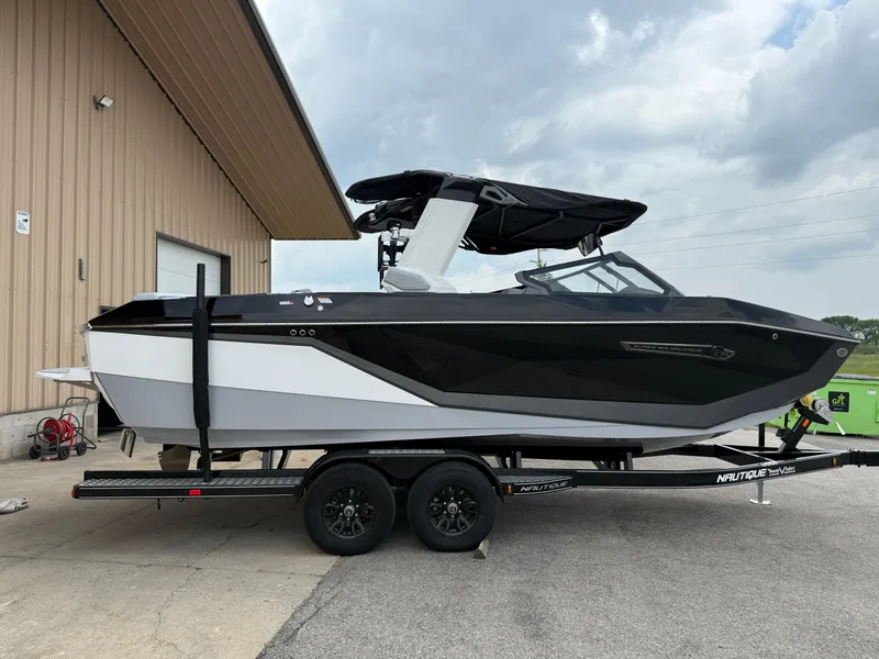 Slide: The Image of 2025 Nautique Super Air Nautique G23 boat on trailer, parked outdoors. - 18