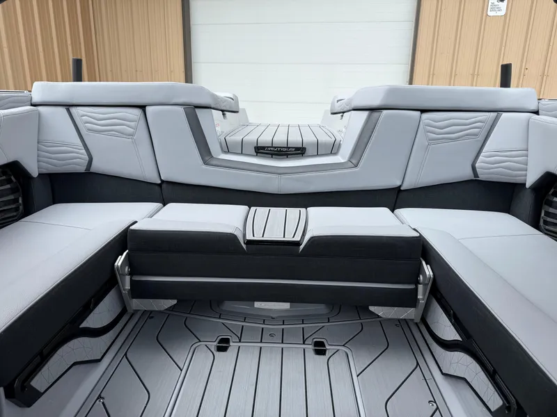 Slide: The Image of 2025 Nautique Super Air Nautique G23 interior with sleek gray seating and modern design. - 26