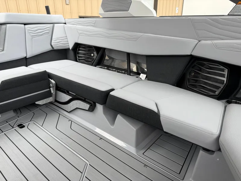 Slide: The Image of 2025 Nautique Super Air Nautique G23 interior with sleek gray seating and modern design. - 27