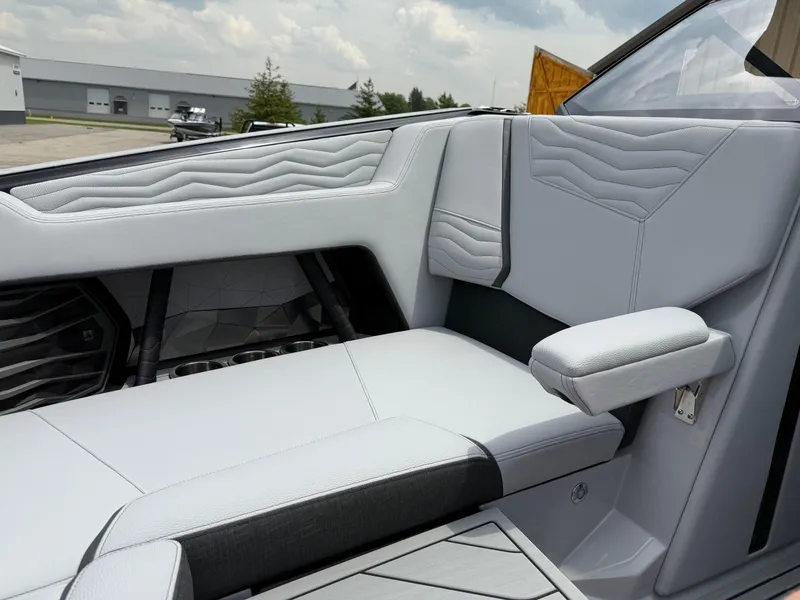 Slide: The Image of 2025 Nautique Super Air Nautique G23 interior with sleek, modern seating and armrest design. - 31