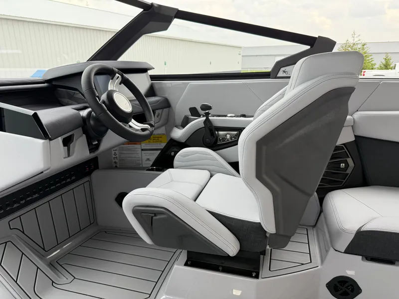 Slide: The Image of 2025 Nautique Super Air Nautique G23 interior with modern steering and seating design. - 33