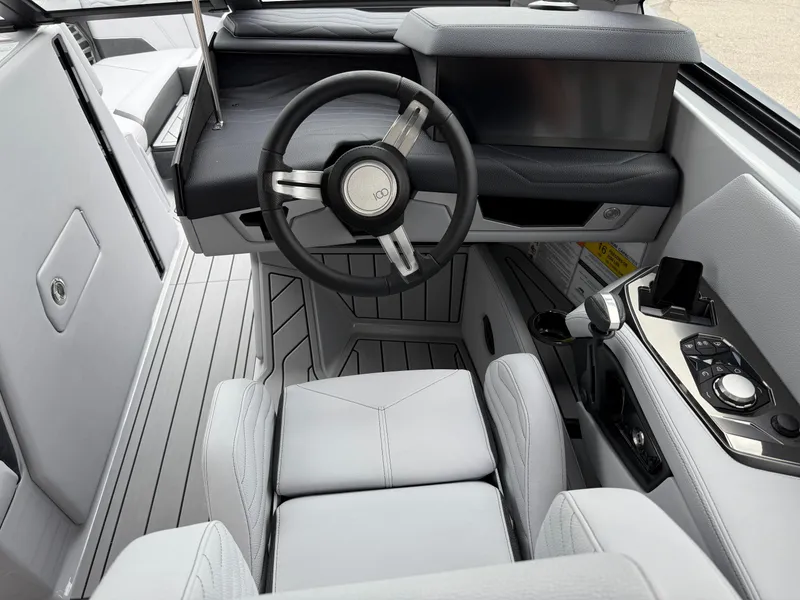 Slide: The Image of 2025 Nautique Super Air Nautique G23 cockpit with modern steering and control panel. - 35