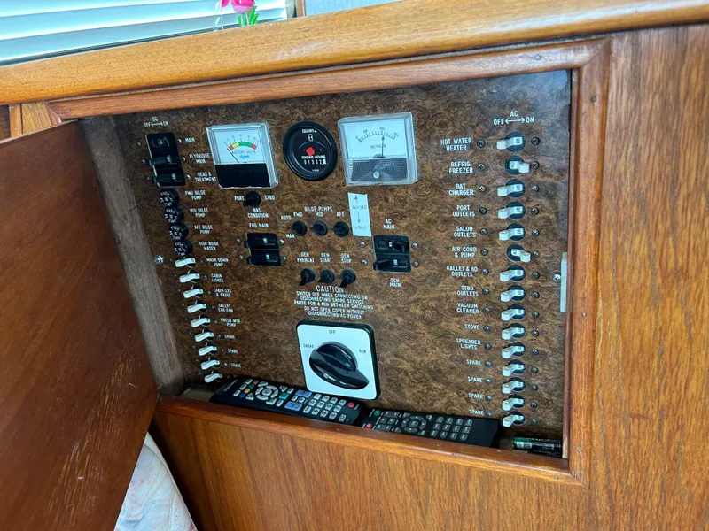 Slide: The Image of Electrical control panel on a 1989 Ocean Yachts Super Sport boat, featuring various switches and meters. - 13