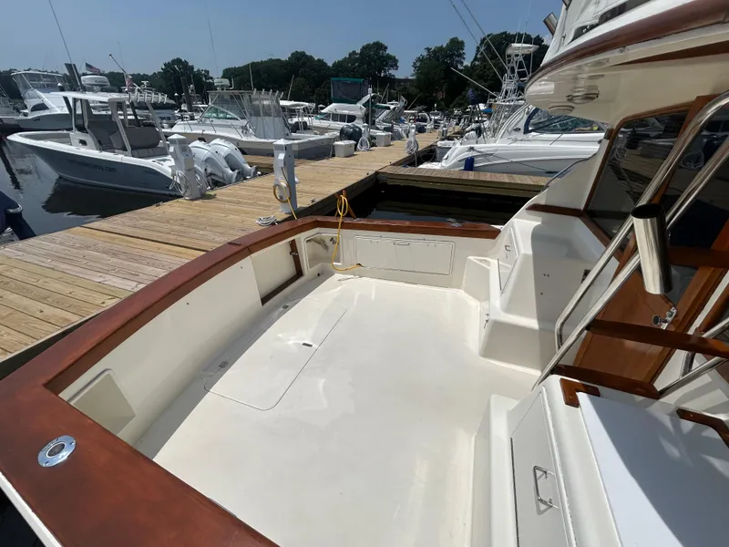 Slide: The Image of 1989 Ocean Yachts Super Sport docked, showcasing spacious deck and sleek design. - 4