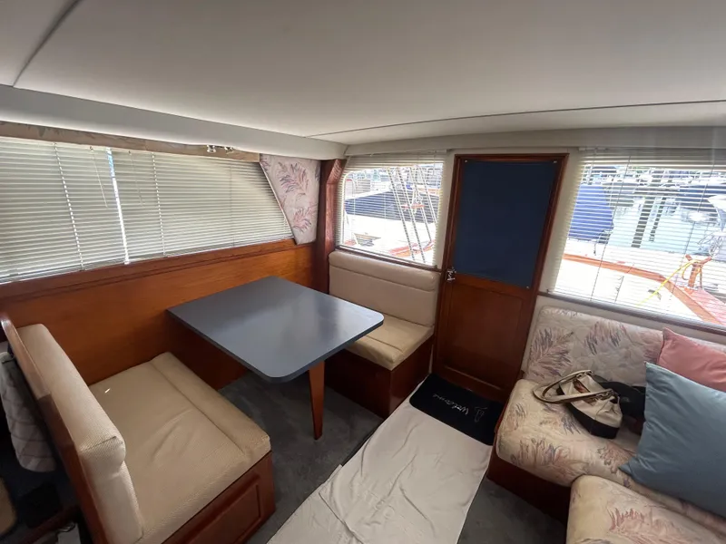 Slide: The Image of Interior of 1989 Ocean Yachts Super Sport with seating, table, and windows. - 8