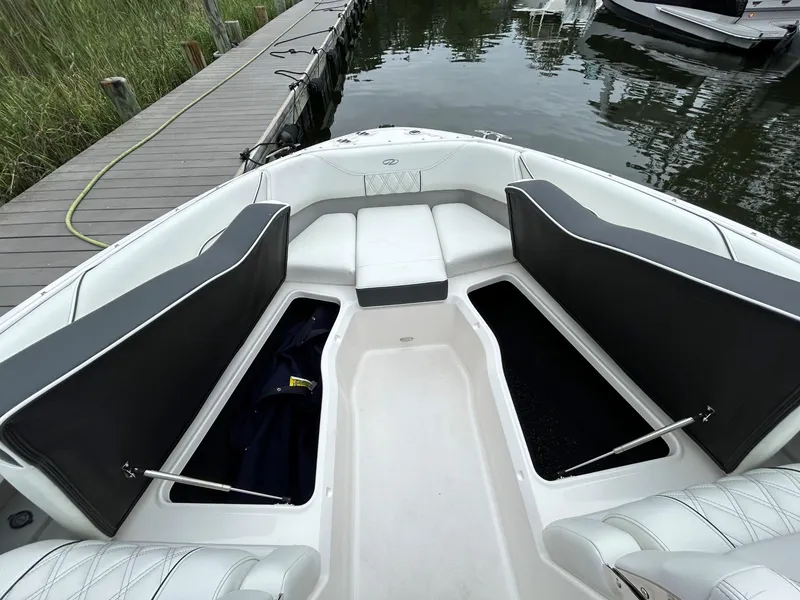 Slide: The Image of 2026 Regal LX4 boat interior with open storage compartments at dockside. - 10