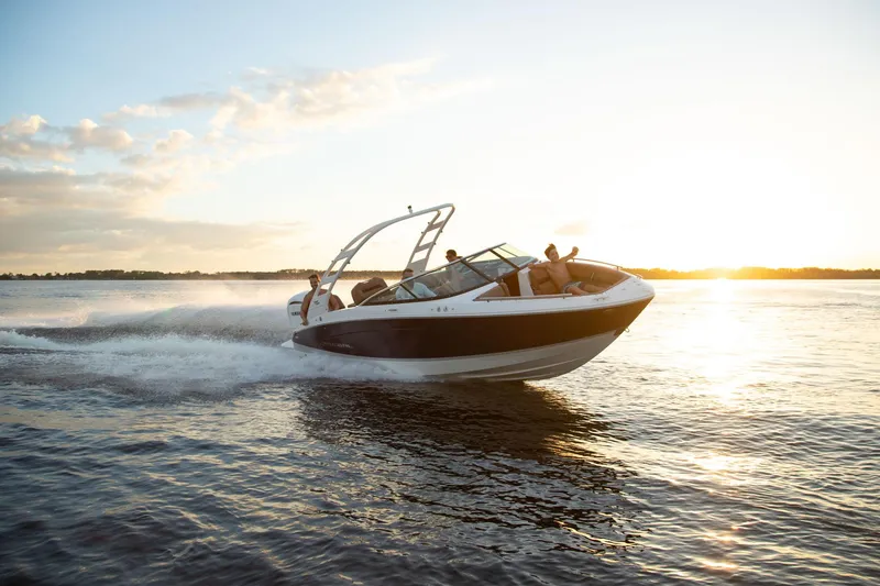 Slide: The Image of 2026 Regal LX4 boat cruising on a lake at sunset. - 12