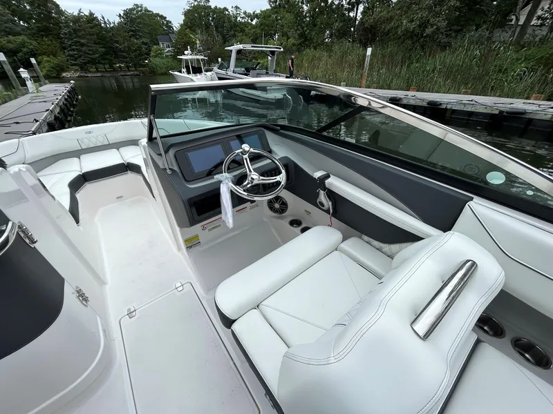 Slide: The Image of 2026 Regal LX4 boat interior with sleek white seating and modern dashboard. - 5