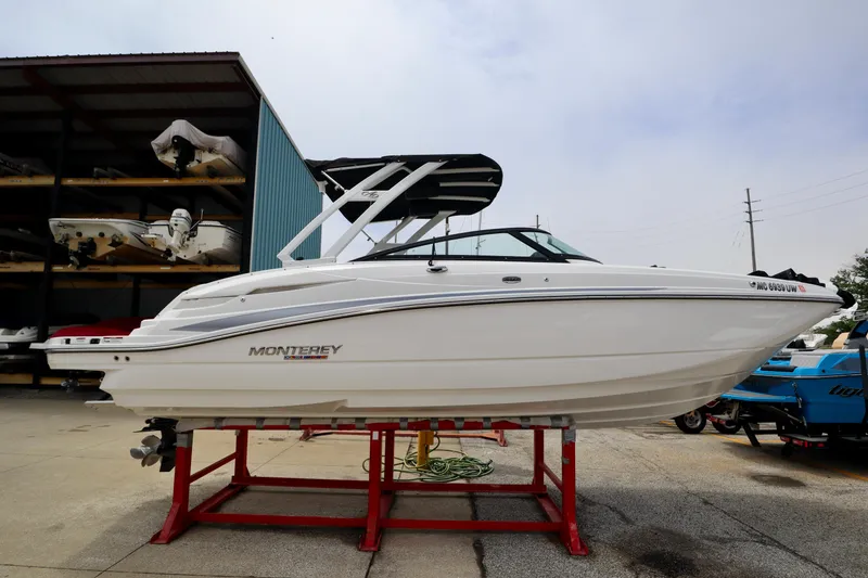 The Image of 2023 Monterey M6 boat on trailer in front of storage racks. - 0