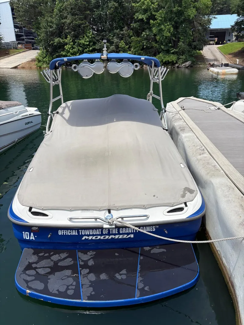 Slide: The Image of 2004 Moomba MOBIUS LS boat docked, covered, with "Official Towboat of the Gravity Games" text. - 12