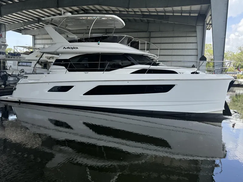 Slide: The Image of Aquila 44 Yacht 2020 model docked in a covered marina. - 11