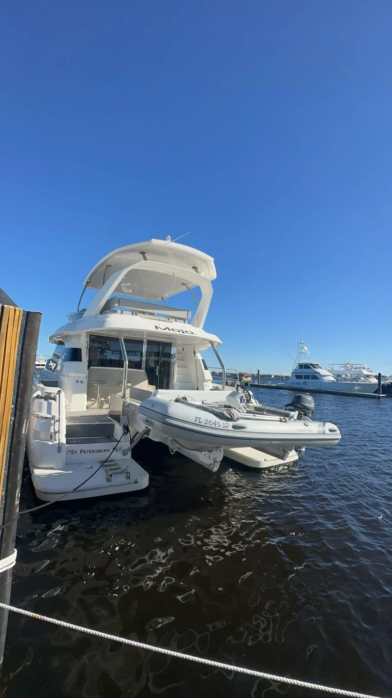 Slide: The Image of Aquila 44 Yacht 2020 docked in sunny marina with clear blue sky. - 12