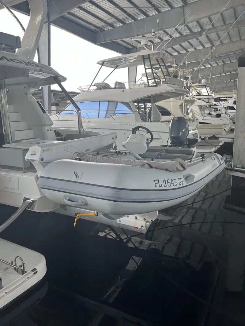 Slide: The Image of Aquila 44 Yacht 2020 with inflatable boat docked in marina. - 13