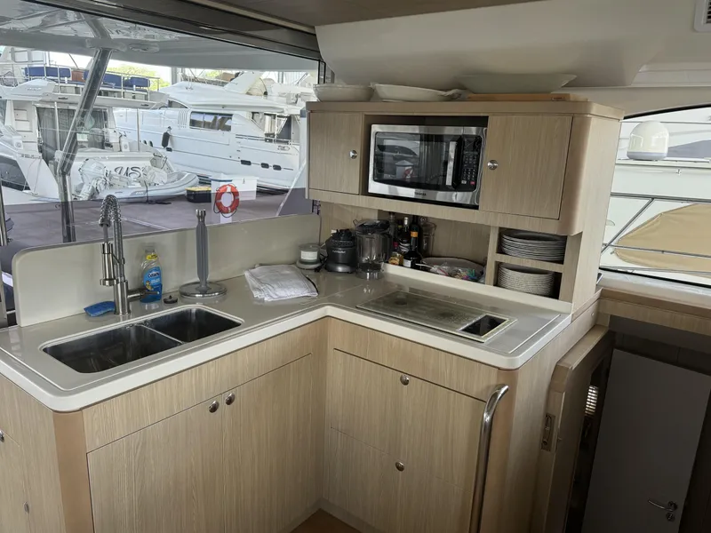 Slide: The Image of Modern kitchen interior on 2020 Aquila 44 Yacht with sink, microwave, and storage. - 4