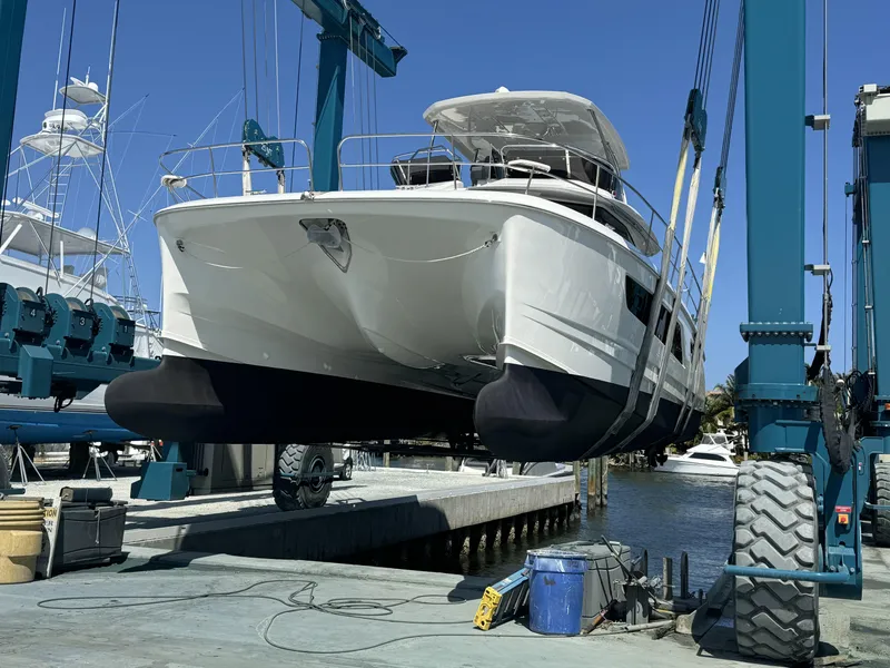 Slide: The Image of Aquila 44 Yacht 2020 in dry dock, suspended by a boat lift. - 6
