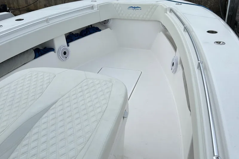 Slide: The Image of 2023 Invincible 36 Open Fisherman boat interior with white cushioned seating and speakers. - 10