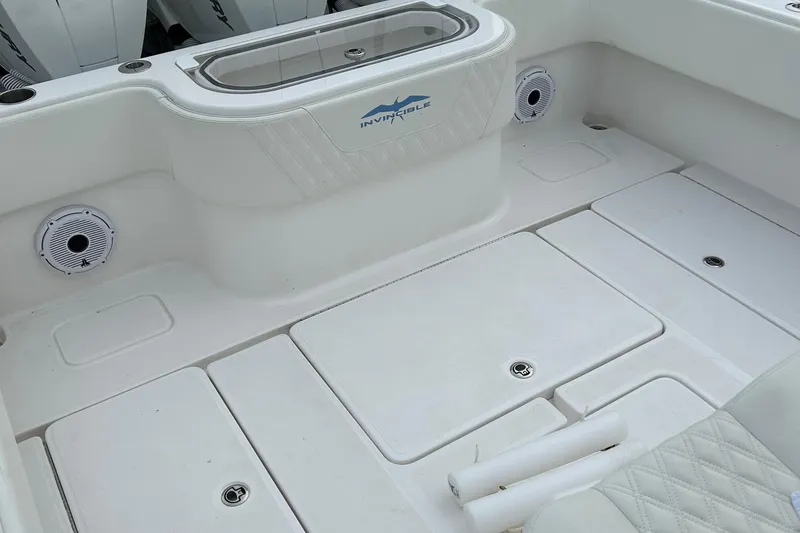 Slide: The Image of 2023 Invincible 36 Open Fisherman boat interior with storage compartments and speakers. - 11