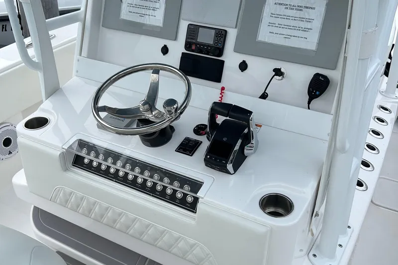 Slide: The Image of Control panel of 2023 Invincible 36 Open Fisherman boat with steering wheel and electronics. - 12