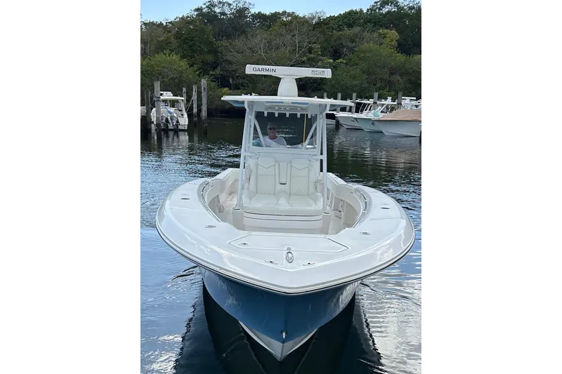 Slide: The Image of 2023 Invincible 36 Open Fisherman boat on calm water, featuring sleek design and advanced Garmin technology. - 2
