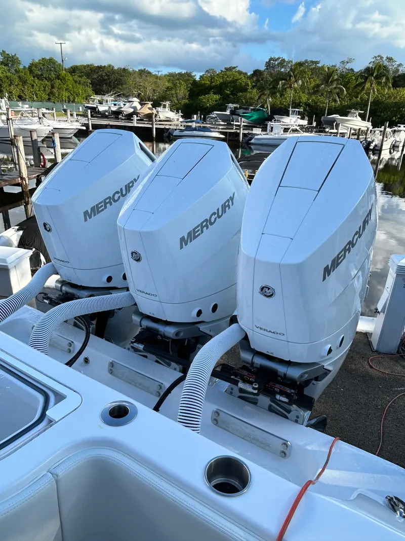 Slide: The Image of Triple Mercury outboard engines on 2023 Invincible 36 Open Fisherman boat at marina. - 8