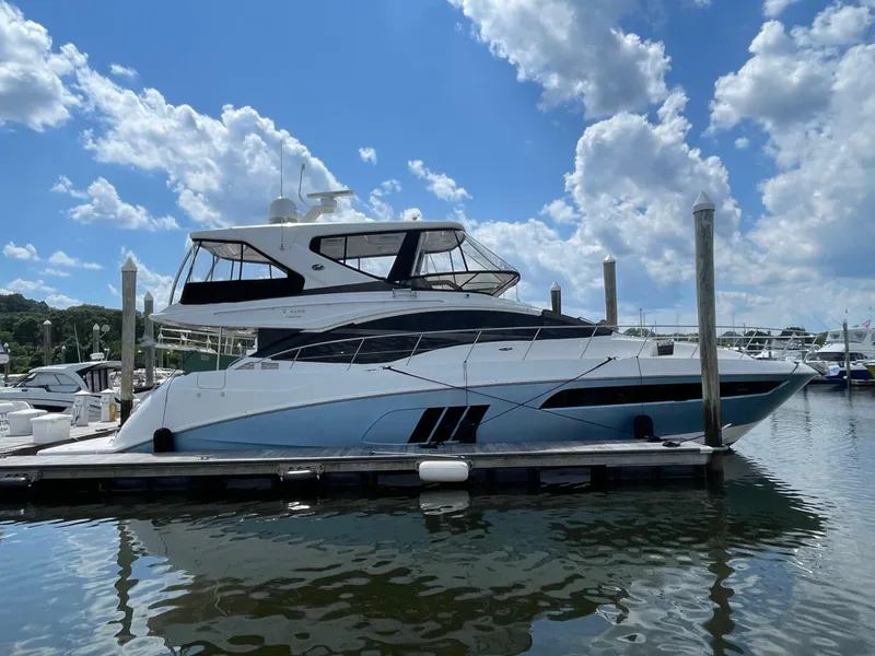 The Image of 2017 Sea Ray L590 Fly yacht docked at marina under blue sky. - 0