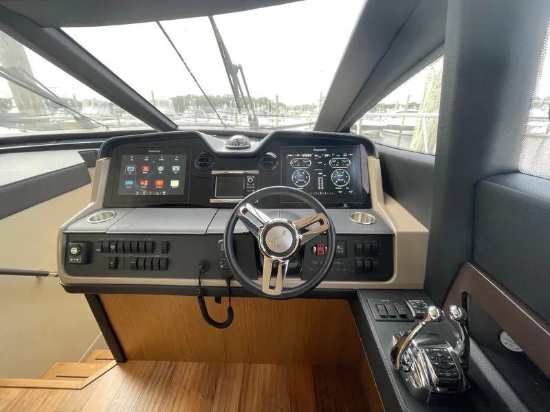 Slide: The Image of 2017 Sea Ray L590 Fly yacht helm with modern controls and navigation displays. - 15