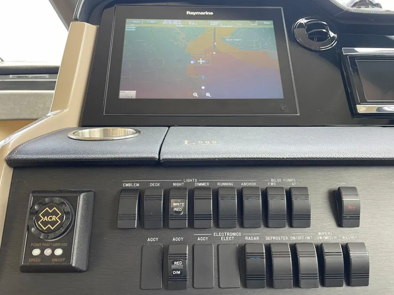 Slide: The Image of Control panel of 2017 Sea Ray L590 Fly yacht with navigation display and switches. - 16