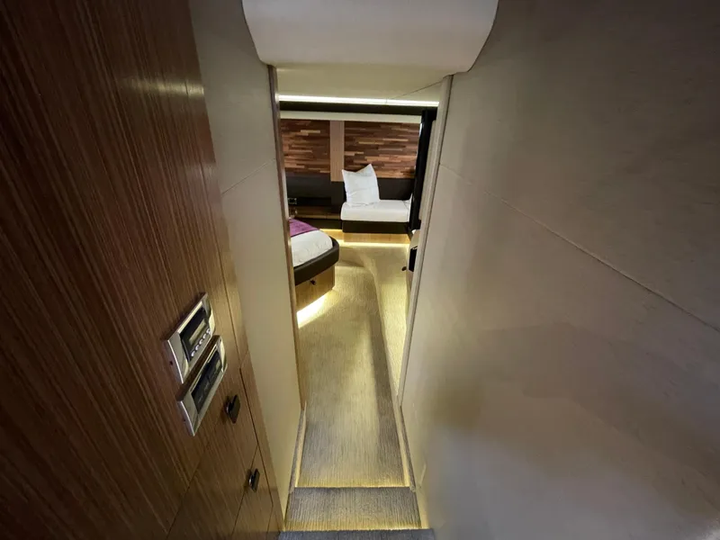 Slide: The Image of Luxurious interior of 2017 Sea Ray L590 Fly yacht, featuring elegant wood paneling and ambient lighting. - 25